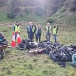 clean up volunteers with load of rubbish collected